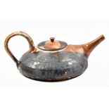 JANE KELLY; a squat stoneware teapot, impressed JK mark and pottery label, height 11cm. (D)