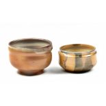 HWANG JENG-DAW (born 1963); two wood fired stoneware footed tea bowls with ash glaze decoration,