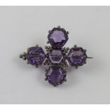 A Victorian silver cross-form brooch set with five hexagonal-cut amethysts surrounded in ball-form