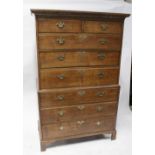 A George III oak chest-on-chest with dentil moulded cornice above two short and six long graduated