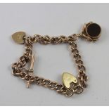 A 9ct gold bracelet with heart clasp, T-bar, swivel seal and heart charm, approx 17g.