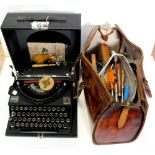 A cased Imperial typewriter and a leather bag containing various tools.