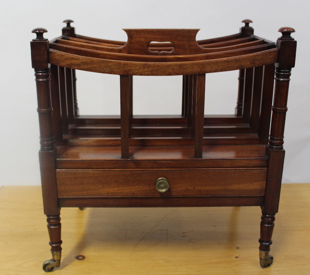 A 19th century mahogany Canterbury with single base drawer, raised on brass casters, height 50cm.