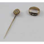 A yellow metal band ring set with three small seed pearls (unmarked,