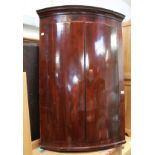 A Victorian inlaid mahogany bow-front hanging corner cupboard, height 107cm.