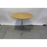 A chromed base circular maple kitchen table,