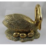A large brass nesting swan with three brass eggs to the base with one semi hatched, height 28cm,