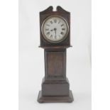 An early 20th century oak miniature grandfather clock, the white dial set with Roman numerals,