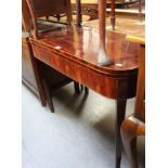 A 19th century mahogany fold-over tea table, raised on block supports, length 91cm.