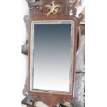 A 19th century mahogany-framed Chippendale-style wall mirror with carved eagle surmount,