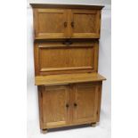 A 20th century oak Hoosier kitchen cabinet with fitted interior comprising pair of cupboards above