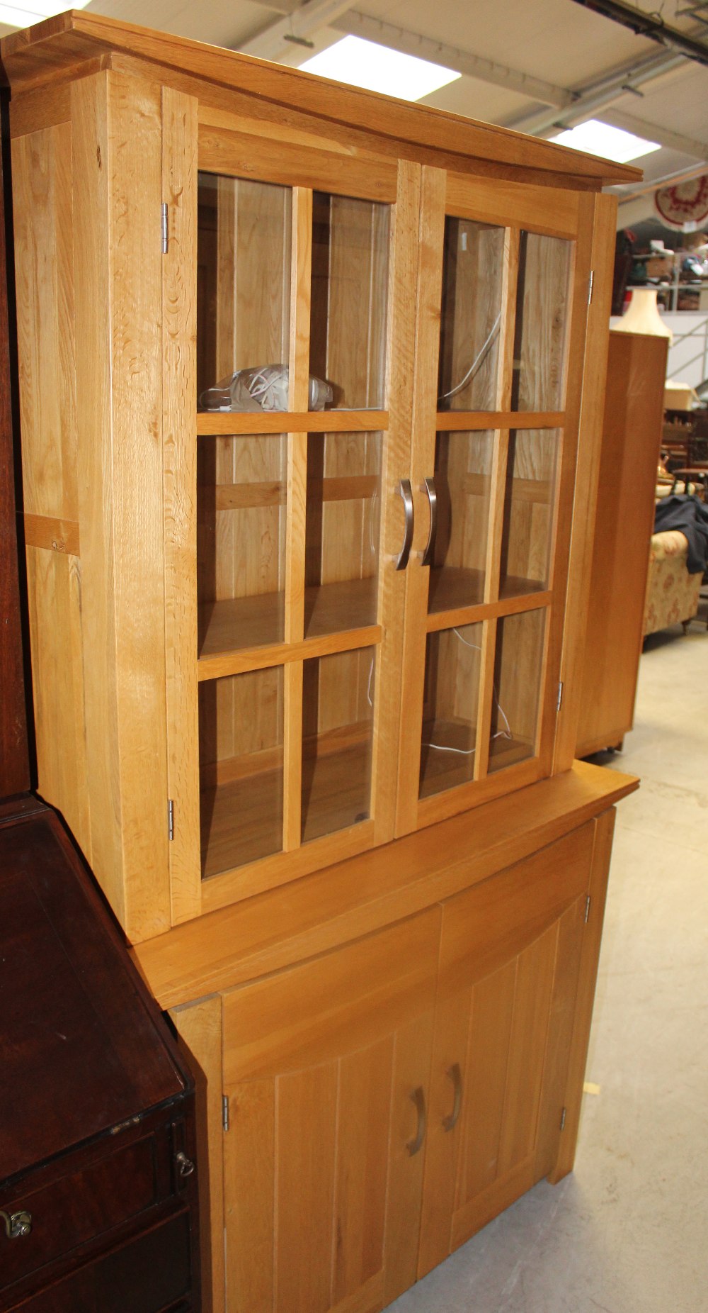 A modern light oak dining room suite comprising display cabinet, dining table,