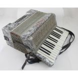 An Alvari piano accordion in mother of pearl effect case.