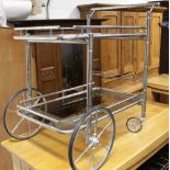A Heals vintage chrome and smoky glass two-tier drinks trolley with faux bamboo rails and four