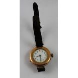 A ladies' wristwatch, the white enamelled dial within a 9ct gold mount on leather strap.