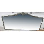 A very large overmantel mirror, the arched top with central bouquet of flowers,