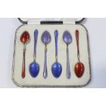 A cased set of six enamelled spoons.