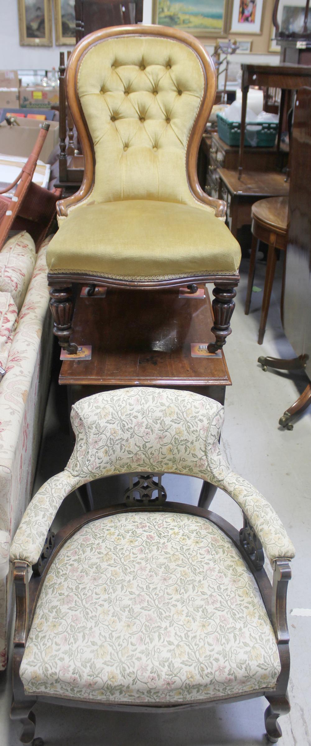 A Victorian spoon-back walnut-framed armchair with yellow upholstery and a floral upholstered