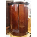 A Victorian inlaid mahogany bow-front hanging corner cupboard, height 107cm.