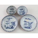 Two Chinese blue and white porcelain tea bowls and saucers decorated with landscape scenes,