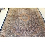 A large blue ground carpet with orange detail, 260 x 360cm.