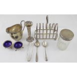 A group of variously hallmarked silver items to include a Chester milk jug, Toast rack,