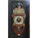 A reproduction cast metal and wooden wall clock,
