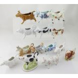 A collection of thirteen modern cow creamer ornaments (13).