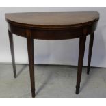 A 19th century inlaid mahogany demi-lune fold-over tea table, raised on spade feet, length 91cm.