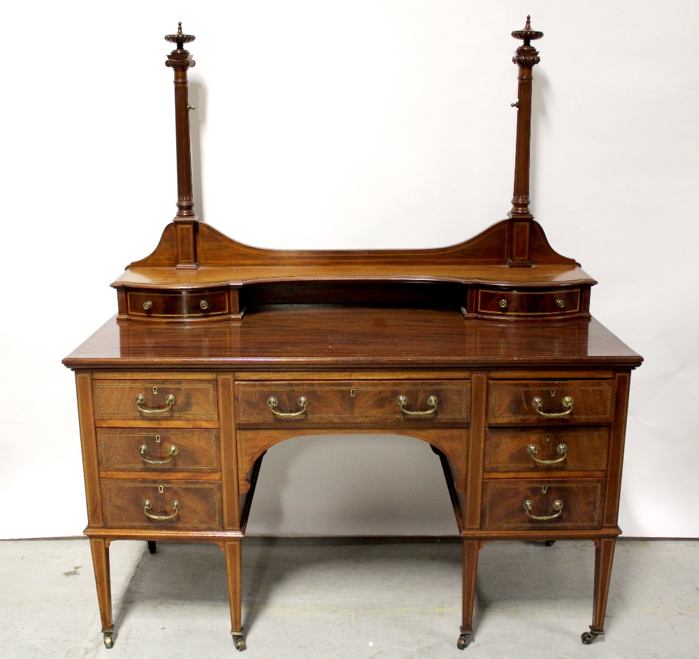 An Edwardian mahogany and inlaid dressing table (lacking mirror) with arrangement of nine drawers,