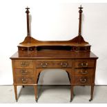 An Edwardian mahogany and inlaid dressing table (lacking mirror) with arrangement of nine drawers,