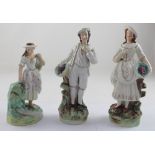 Three Staffordshire Thomas Parr figures, the pair as lady and gentleman with basket of grapes,