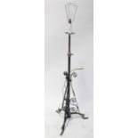 A brass standard lamp, the column set with three candle sconces,