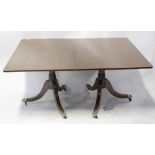 A reproduction inlaid oak twin-pedestal dining table with one extra leaf,