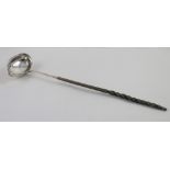 A 19th century white metal toddy ladle with baleen handle, unmarked, length 37cm.
