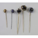 A Victorian mourning tie pin set with cabochon onyx surmounted with a diamond in a star-form