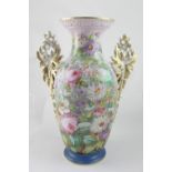 A large Continental porcelain baluster vase with gilt porcelain handles of leaves and berries,
