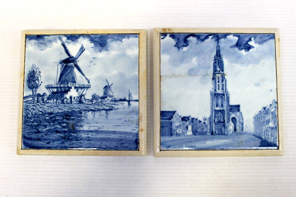 Two 19th century blue and white Delft tiles hand painted with a windmill scene and church scene,