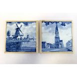 Two 19th century blue and white Delft tiles hand painted with a windmill scene and church scene,