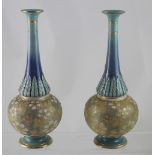 A pair of Doulton Lambeth vases of gourd form with pressed Chinoiserie decoration in blue.