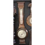 An early 20th century mahogany wall barometer with silvered dial above presentation plaque