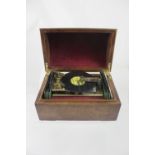 A late 20th century Swiss disc music box, walnut dome top case, together with six Thorens discs.