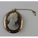 A shell cameo carved with the bust of a Classical lady wearing a garland in her hair,