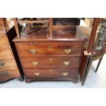 A Georgian mahogany straight-front chest of drawers with slide above three long drawers,