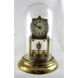 An early 20th century brass anniversary clock, the circular dial with Arabic numerals,