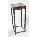A Chinese carved hardwood jardinière stand with square top raised on carved block supports,