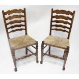 A part set of five (4+1) ladder-back elm dining chairs with rush seats and a reproduction refectory