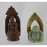 Two carved hardstone Buddhas, the goldstone example on double lotus base (af), height 17.5cm (2).