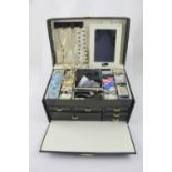 A black jewellery case containing mixed costume jewellery including fashion watches, necklaces,
