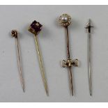 Four gem-set tie pins comprising a circular yellow metal pin centrally set with pearl in a surround